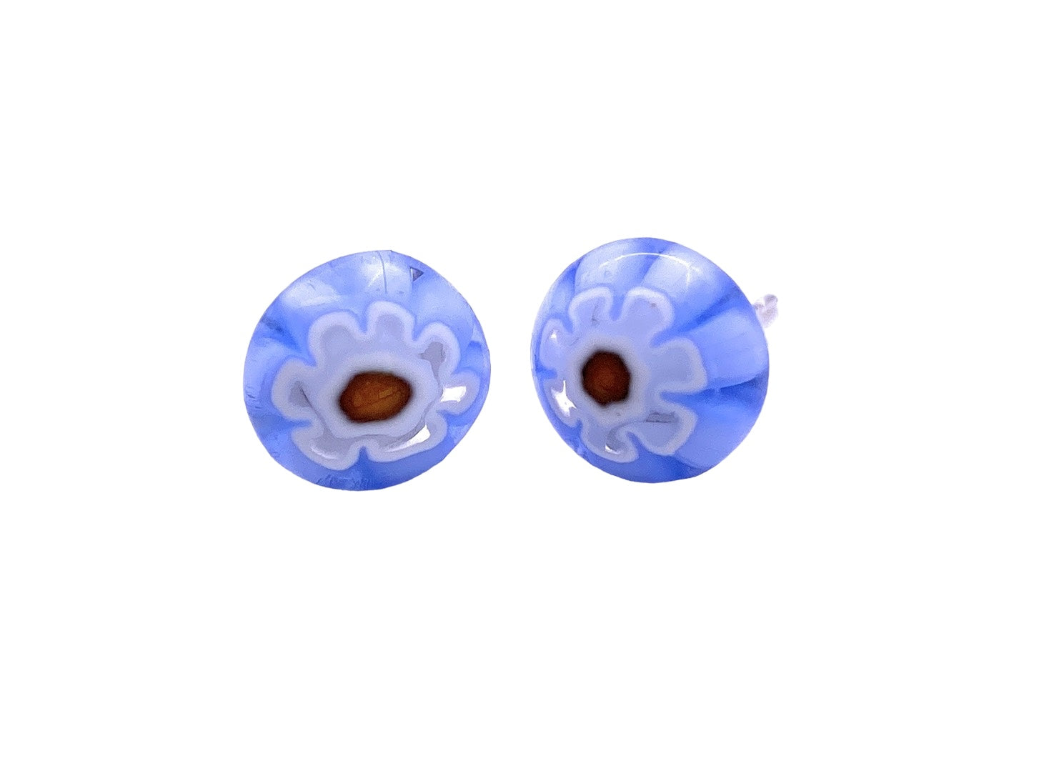 The Handmade Millefiori Glass Stud Earrings by Calon Glass feature a pair of blue glass beads with a swirling white pattern and a brown center, designed to resemble an eye. These dainty 0.9 cm floral earrings are crafted using traditional millefiori glass techniques and have a glossy finish, beautifully showcased against a plain white background.