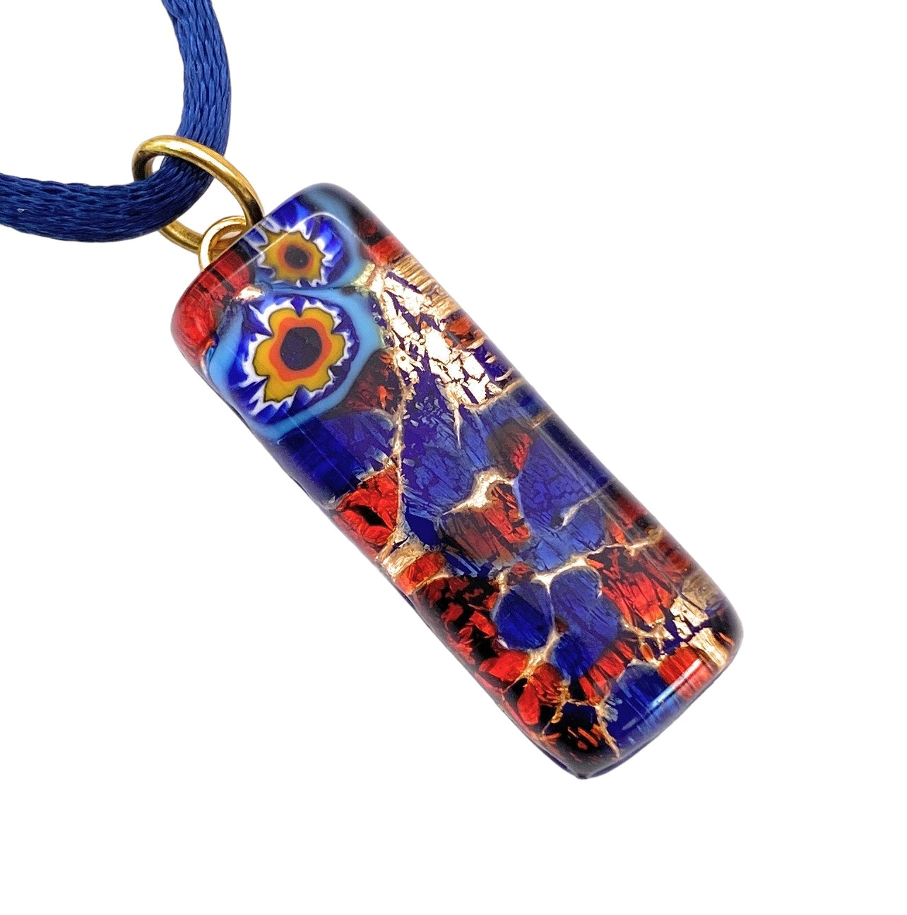 The Murano Passion Pendant showcases Millefiori flowers on a gold leaf design, measuring 3cm by 1cm. It comes on a blue cord and is adorned with vibrant blue, red, and gold abstract patterns along with small circular designs. Finished with a glossy sheen and featuring a gold loop, this exquisite piece of jewelry is accompanied by a Certificate of Authenticity.