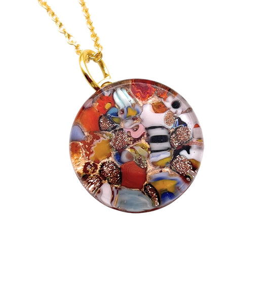 A Murano Passion Glass Round Pendant made with Millefiori stands out with its vibrant mosaic of red, blue, white, black, and gold swirls, elegantly suspended on a gold chain. This exquisite 2cm piece from Murano Passion comes with a Certificate of Authenticity.