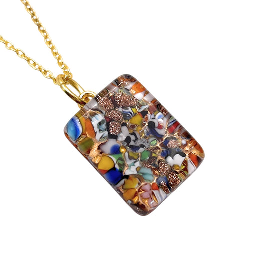 A Murano Passion MGPP15 Pendant, featuring a rectangular design with Millefiori pieces on gold leaf in vibrant blue, yellow, green, and copper accents, elegantly suspended from a gold chain.