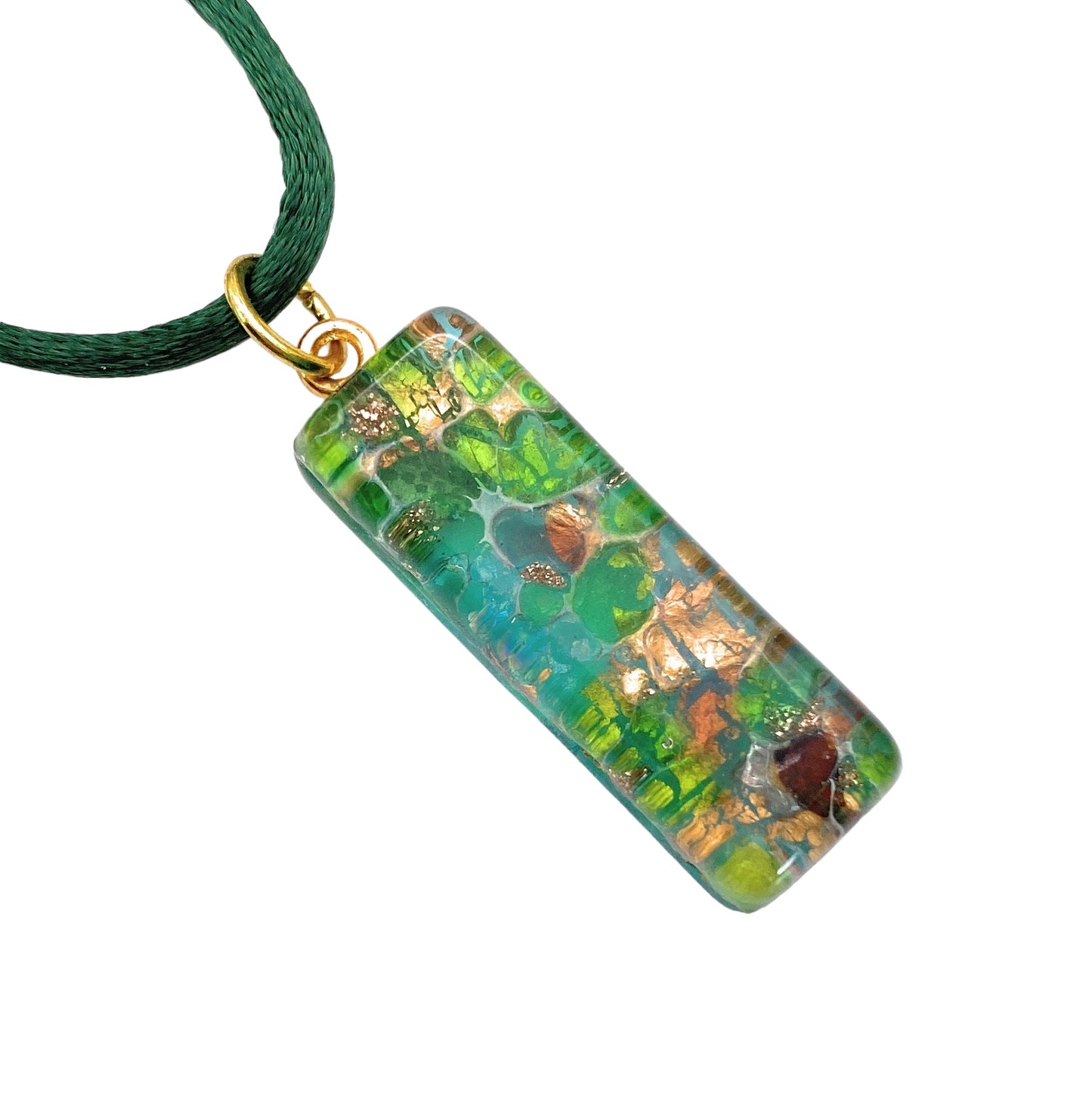 Introducing the Murano Passion Murano Glass Pendant made using Gold Leaf (MGPL9), a stunning handmade jewelry piece with a marbled texture and an energetic blend of green, blue, and gold. This 3cm x 1cm rectangular pendant is beautifully encased in resin and elegantly suspended from a dark green cord with a gold-colored ring.