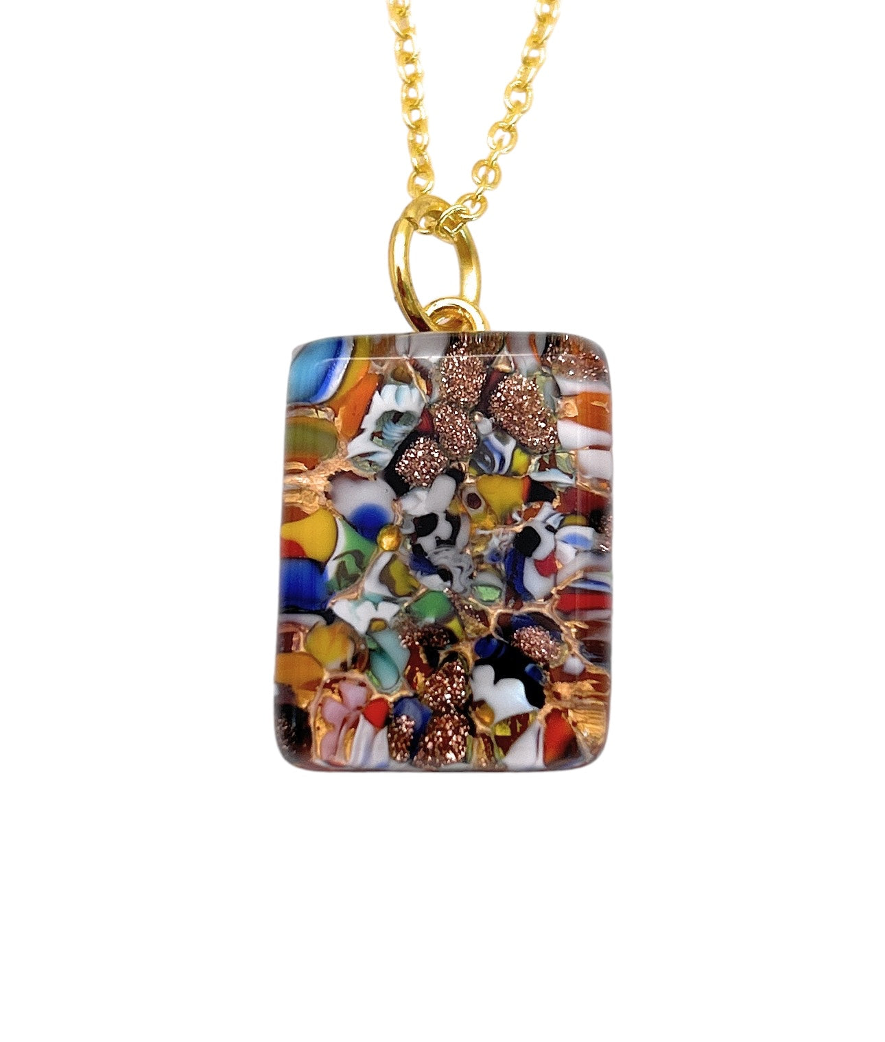 A vibrant Murano Passion pendant, crafted with Millefiori pieces on gold leaf, measures a dainty 2cm by 1.5cm and hangs from a gold chain. The design showcases an abstract mosaic-like pattern in vibrant colors such as blue, red, yellow, and white.