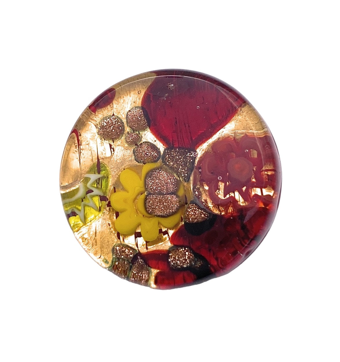 The Murano Glass Brooch with Millefiori on a Gold Leaf Base, crafted by Murano Passion, showcases intricate Venetian artistry. It features vibrant designs with red and gold swirls, glittery accents, and a prominent yellow flower at its center, making it truly eye-catching.