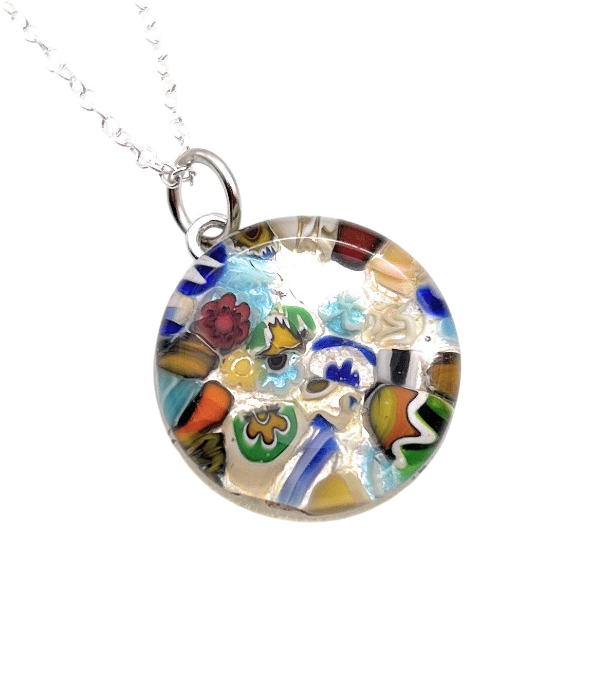 The Murano Glass Round Pendant made with Millefiori by Murano Passion, measuring 2cm, showcases vibrant abstract patterns in red, blue, green, yellow, and orange hues. It hangs elegantly from a silver chain and comes with a Certificate of Authenticity to guarantee its genuine craftsmanship.