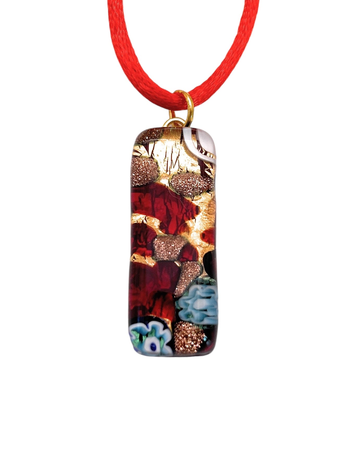 The Murano Passion pendant, crafted from Murano glass using the millefiori technique on gold leaf, features a vibrant rectangular mosaic design in red and green with floral patterns. It elegantly hangs from a bright red cord and comes with a Certificate of Authenticity. Dimensions: 3cm x 1cm (MGPL3).