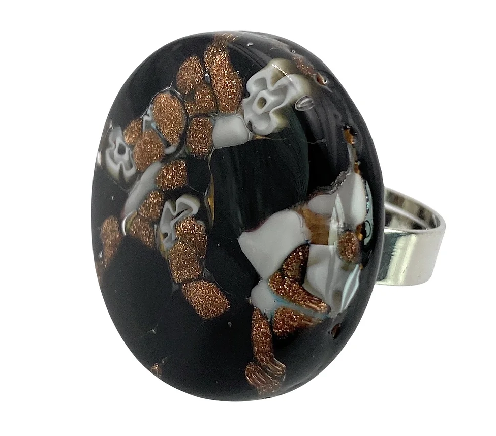 This striking Murano Passion ring features a bold, 3cm stone with intricate millefiori patterns on gold leaf, reminiscent of genuine Murano Glass. Set in a simple silver band, the design exudes abstract elegance and exceptional craftsmanship.