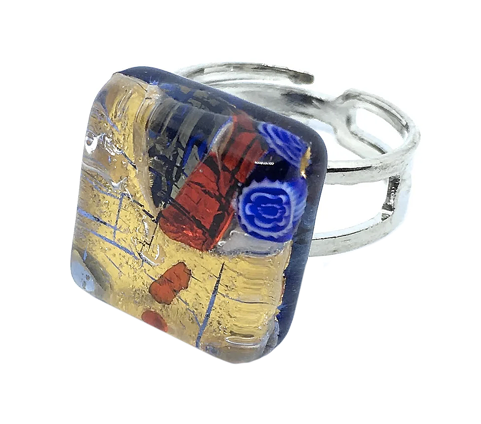 The Murano Passion Murano Glass Ring, Millefiori Pieces on Gold Leaf, showcases a dainty 1.5cm square design featuring a colorful mosaic pattern that combines vibrant shades of blue, red, and gold.