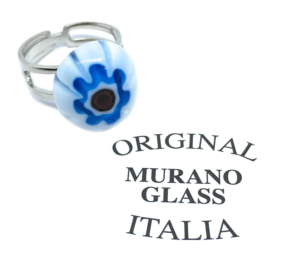 A silver adjustable Murano Passion ring features a dainty 1.6cm x 1.4cm Murano Glass bead adorned with a blue floral design on a white background, embodying Venetian heritage. The nearby text reads "Original Murano Glass Italia.