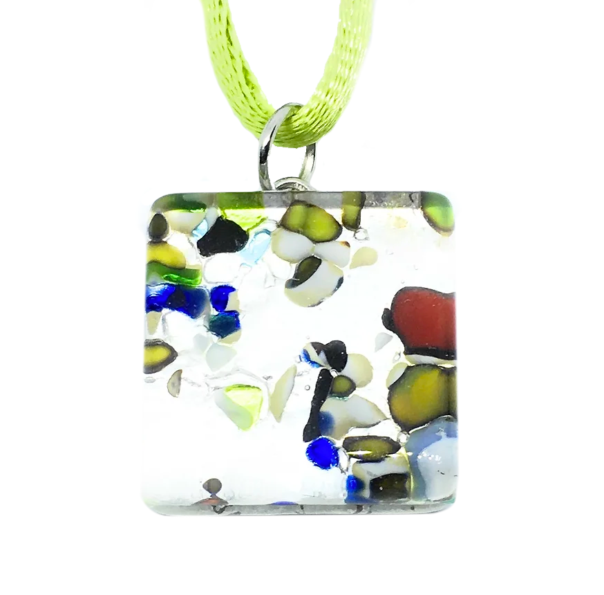 A Murano Passion Millefiori Pendant on Silver Leaf, measuring 2cm by 2cm, displays multicolored abstract patterns in shades of blue, green, red, and black and is elegantly suspended from a light green ribbon.