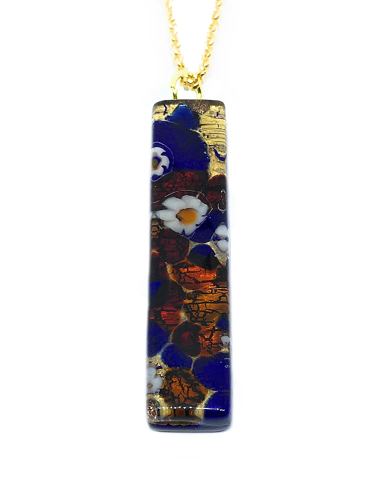 The Murano Passion Murano Glass Pendant on Gold Leaf, measuring 4cm by 1cm, features a gold chain and showcases a vibrant design of blue, red, and white floral patterns with gold accents. The colors blend in a mosaic-like style, creating a striking and elegant appearance that exemplifies the artistry of Murano pendants.