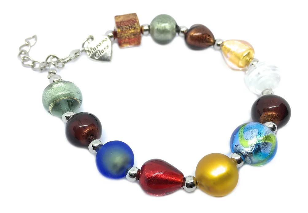 The Murano Passion bracelet, crafted with Murano Glass beads ranging from 0.5cm to 1cm, features a stunning array of vibrant colors such as metallic reds, blues, greens, and gold with elegant silver accents. It includes a heart-shaped tag near the clasp engraved with "Murano Glass," confirming its authenticity alongside an included Certificate of Authenticity.