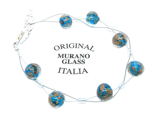 A bracelet featuring dainty 8mm aqua blue Murano glass beads with gold accents encircles the phrase "Original Murano Glass Italia." This exquisite piece from Murano Passion comes with a Certificate of Authenticity, assuring its genuine artisanal craftsmanship.