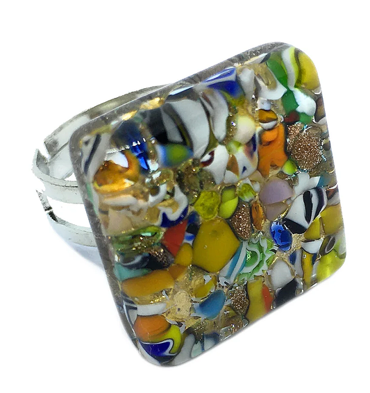 Introducing the Murano Passion Murano Glass Ring, crafted with Millefiori on Gold Leaf. This 2cm x 2cm square-shaped ring features a mosaic of vivid green, blue, yellow, orange, and white hues. Set gracefully in a silver band, this handmade piece exemplifies the vibrant elegance of authentic Murano craftsmanship.