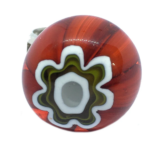 The Murano Passion offers a 1.8cm ring made from Murano Glass, showcasing a glossy spherical bead adorned with a swirl pattern on a red base. The design features concentric rings in white, green, and gray, capturing the essence of Venetian artistic heritage with an abstract floral motif at its center using the Millefiori flower technique.