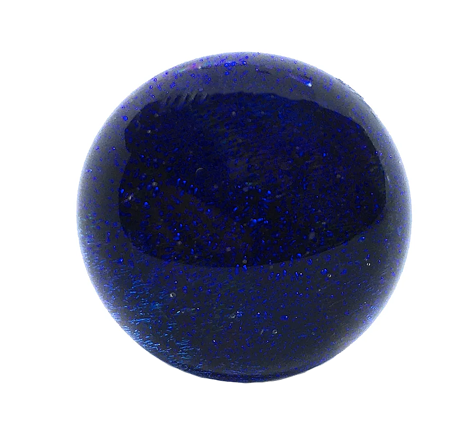 The Handmade Dichroic Glass Ring by Calon Glass features a 1.7cm deep blue dichroic glass centerpiece with tiny bubbles within, set in an adjustable silver-plated band. The textured and reflective qualities of the dichroic glass contrast beautifully with its smooth, glossy spherical shape, making it a striking statement piece.