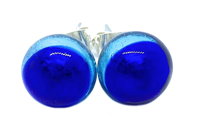 A close-up of Murano Passion's Murano Glass Earrings in Shades of Blue showcases their dome-shaped 8mm diameter studs and silver backings, highlighting a glossy finish and vibrant color. These exquisite earrings are accompanied by a Certificate of Authenticity, guaranteeing their genuine craftsmanship.