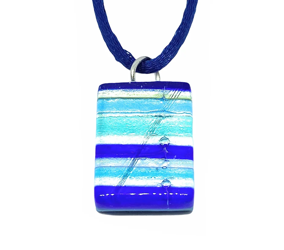 The Murano Passion Murano Glass Pendant on Silver Leaf, measuring 2cm by 1.5cm, showcases horizontal stripes in shades of blue and white with small air bubbles and a glossy finish. It hangs from a blue cord and comes with a Certificate of Authenticity.