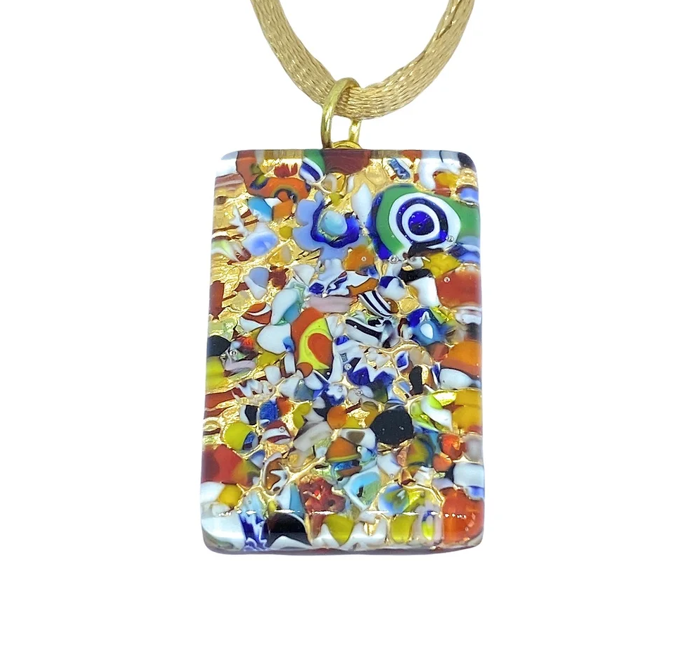 The Murano Passion Pendant is crafted with Millefiori on gold leaf, measuring 3cm x 2cm. Its rectangular shape boasts a vibrant mosaic of abstract patterns in shades of orange, blue, yellow, and red. Attached to a golden cord for an artistic and elegant appearance, it comes with a Certificate of Authenticity.