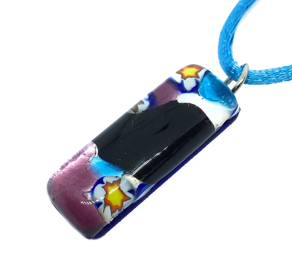 Introducing the Murano Glass Pendant on Silver Leaf by Murano Passion, featuring a vibrant rectangular design with blue, purple, and floral patterns. This exquisite 3cm x 1cm Millefiori art piece is elegantly attached to a blue cord necklace.