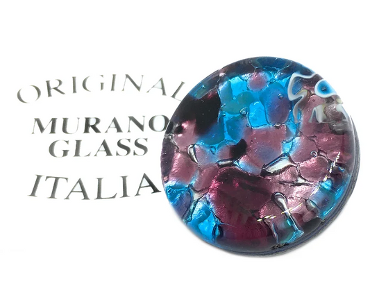 A stunning Murano Glass Brooch from Murano Passion, featuring a 2.4cm circular design with a mosaic pattern in shades of blue, pink, and purple on a silver leaf base, rests on a white surface with the words "Original Murano Glass Italia" partially visible in the background.