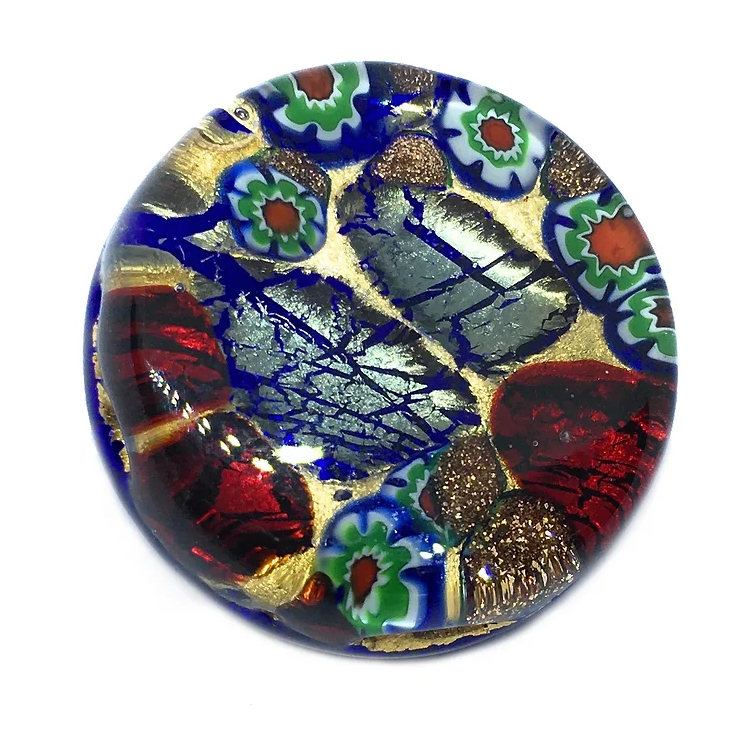 The Murano Passion Murano Glass Brooch with a Gold Leaf Base - 2.4cm features a round, colorful glass piece adorned with intricate patterns and vibrant hues of blue, red, green, and gold. Inspired by Venetian artistic heritage, it includes mosaic-like floral designs and abstract shapes that create a rich, textured appearance.