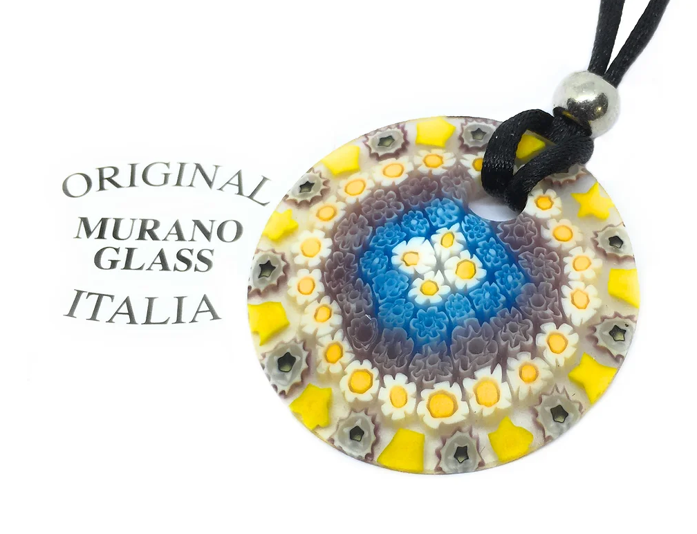 A close-up of the 4cm Murano Glass Pendant made with intricate Millefiori Flowers by Murano Passion features a vibrant display of blue, white, yellow, and gray colors. It hangs from a black cord adorned with a silver bead, embodying the rich Venetian artistic heritage. The text "Original Murano Glass Italia" appears next to the pendant.