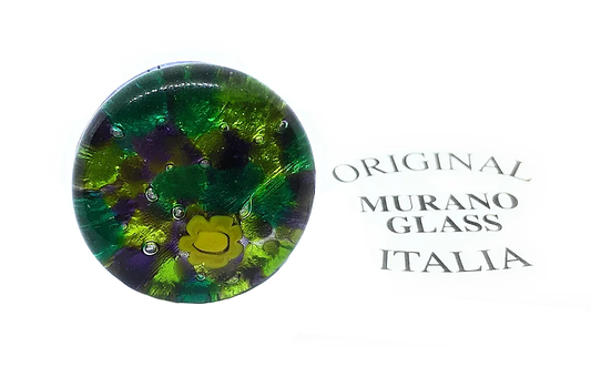 A chunky statement ring by Murano Passion, measuring 2.5cm and handmade in Murano, showcases a vibrant design of green, yellow, and purple tones. The phrase "Original Murano Glass Italia" is elegantly inscribed nearby.