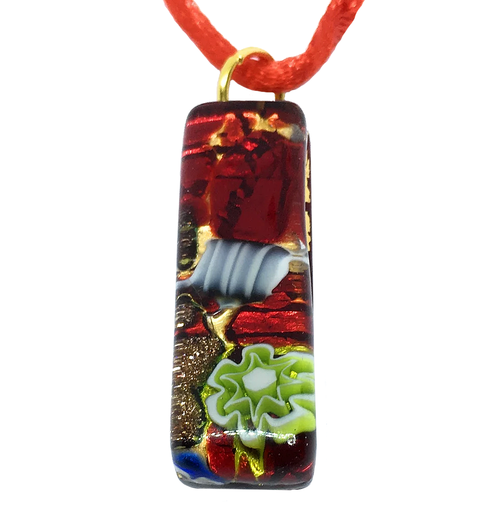 The Murano Passion Millefiori Pendant features an exquisite rectangular design adorned with abstract patterns in red, gold, and black. It showcases a swirled white motif and a vibrant green flower-like shape at the bottom. Elegantly suspended from a red cord with a gold loop, this pendant measures 3cm x 1cm and comes complete with a Certificate of Authenticity to verify its genuine craftsmanship.