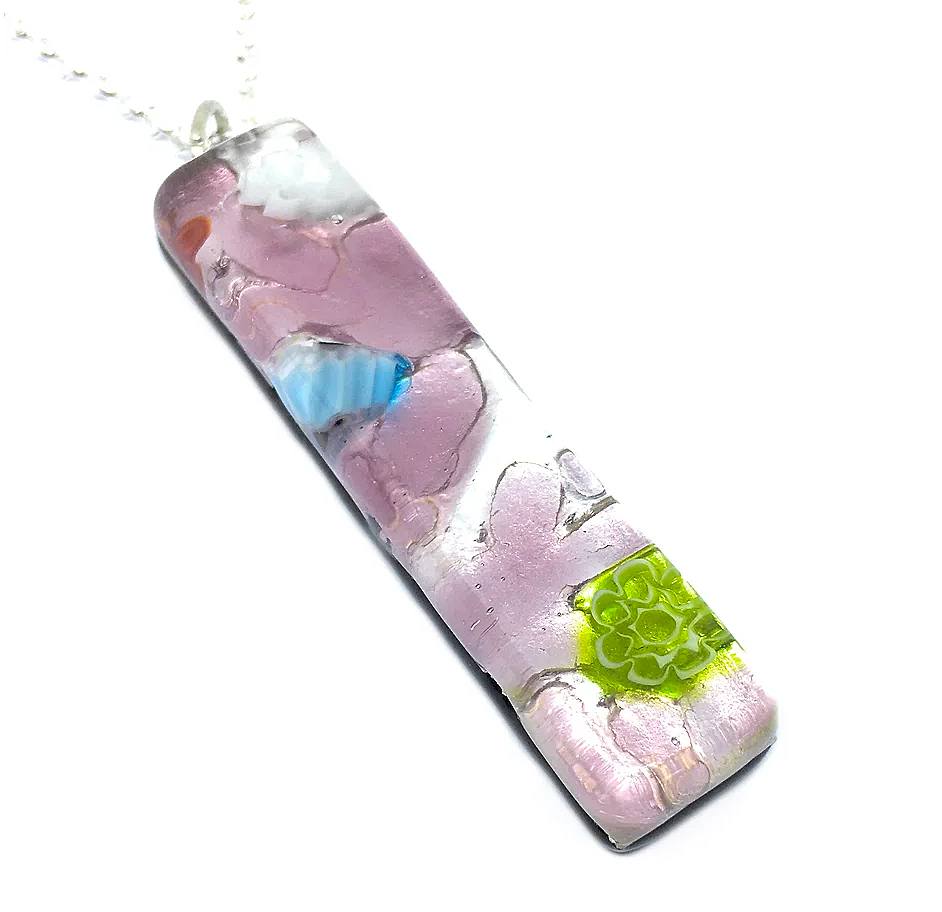 Murano Passion's Murano Glass Pendant measures 4cm by 1cm and features a rectangular shape adorned with floral motifs and abstract patterns in shades of pink, green, and blue, elegantly hanging from a slender chain.