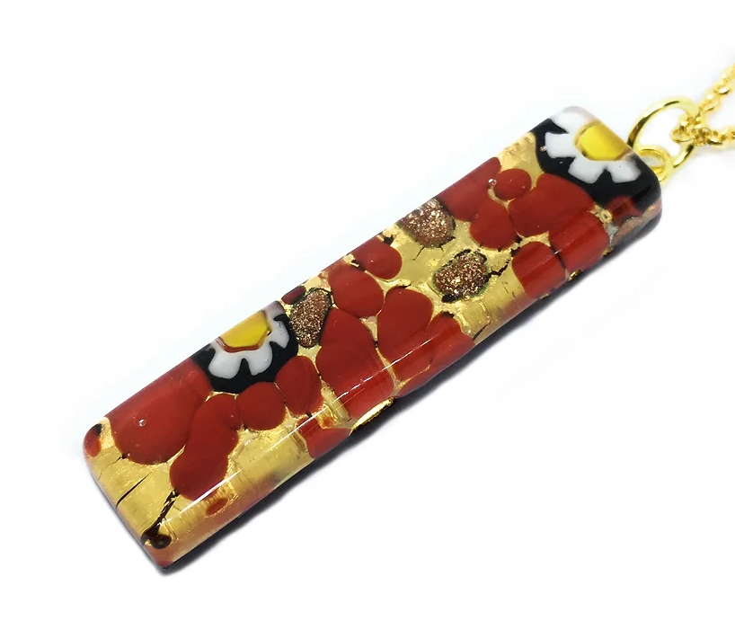 The Murano Passion presents a stunning 4cm x 1cm rectangular Murano Glass Pendant on a gold leaf necklace, featuring intricate red, white, and yellow floral patterns highlighted with gold accents. This piece, reminiscent of decorative art, has a glossy finish and includes a Certificate of Authenticity.