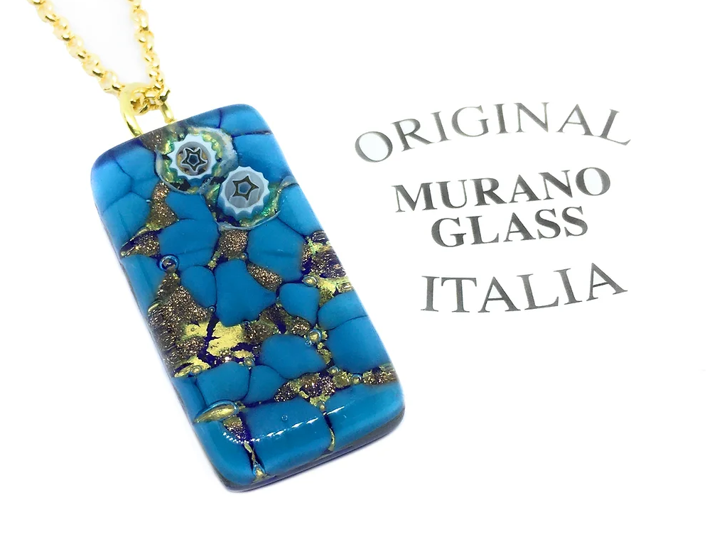 Murano Passion's Millefiori Pendant, crafted from exquisite Murano Glass with gold and star-like patterns, is elegantly suspended on a gold chain. It comes with a Certificate of Authenticity, featuring the inscription “Original Murano Glass Italia” on the right. Dimensions: 3cm x 1.5cm.