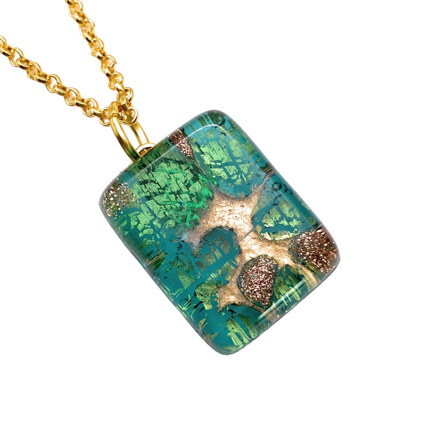 The Murano Passion's Murano Glass Pendant, Green on Gold Leaf (MGPP6), showcases a dainty 2cm x 1.5cm rectangular charm crafted from transparent Murano Glass with embedded green and gold flecks, hanging elegantly from a gold chain for timeless sophistication.