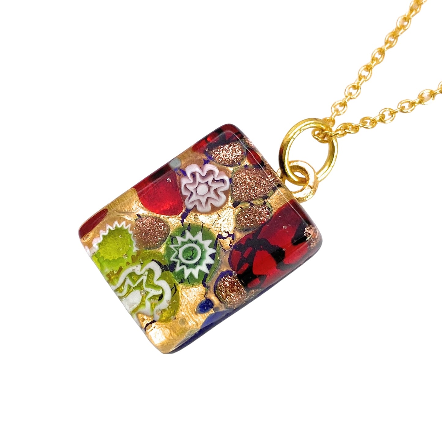 A Murano Passion gold chain necklace featuring the Murano Glass Pendant, Millefiori Flower Pendant on Gold Leaf. This dainty pendant measures 2cm x 1.5cm and boasts a colorful mosaic design with intricate patterns in red, green, gold, and white. The patterns resemble small flowers and geometric shapes embedded in a shiny surface. It also includes a Certificate of Authenticity.