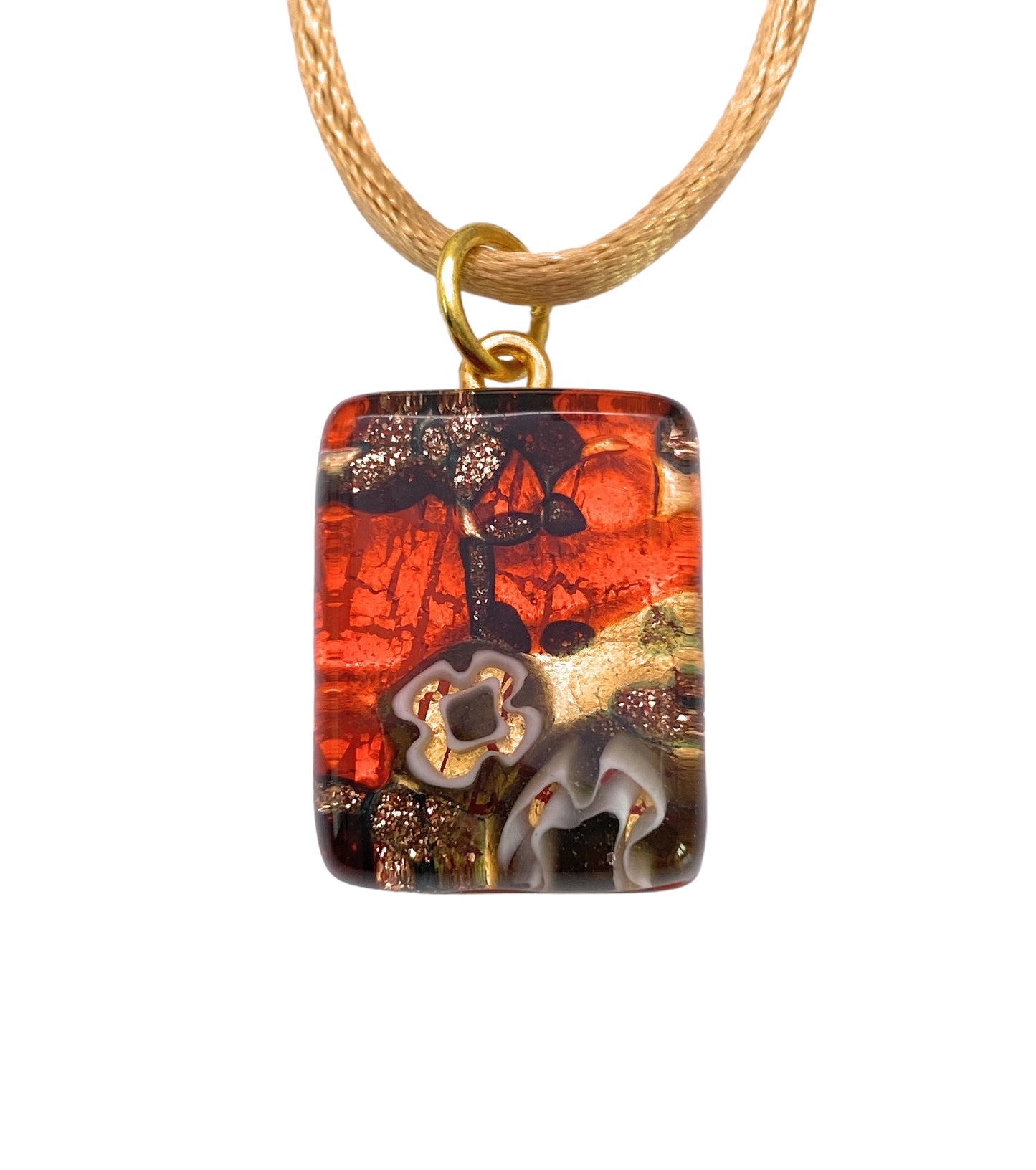 The Murano Passion's Murano Glass Pendant, Millefiori Pendant on Gold Leaf (MGPP26), measures a dainty 2cm x 1.5cm and features a textured design in shades of red, orange, and brown with abstract floral patterns. It is elegantly suspended from a beige cord with a gold ring and includes a Certificate of Authenticity.