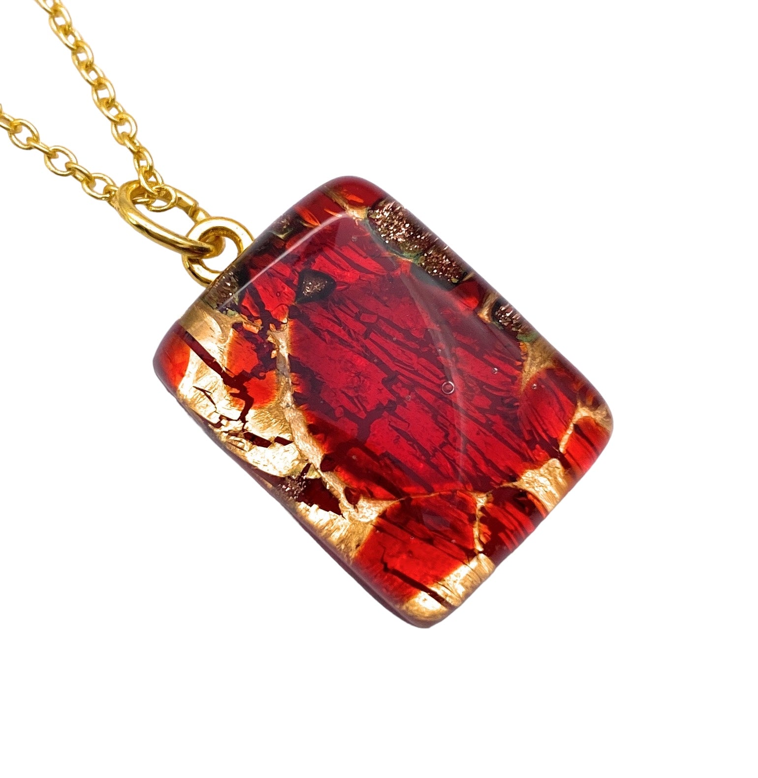 The Murano Passion Murano Glass Pendant on Gold Leaf - Dainty measures 2cm x 1.5cm and features a vibrant red and gold marbled design. It hangs from a gold chain and has a glossy finish that enhances its rich color and intricate pattern, along with being accompanied by a Certificate of Authenticity.